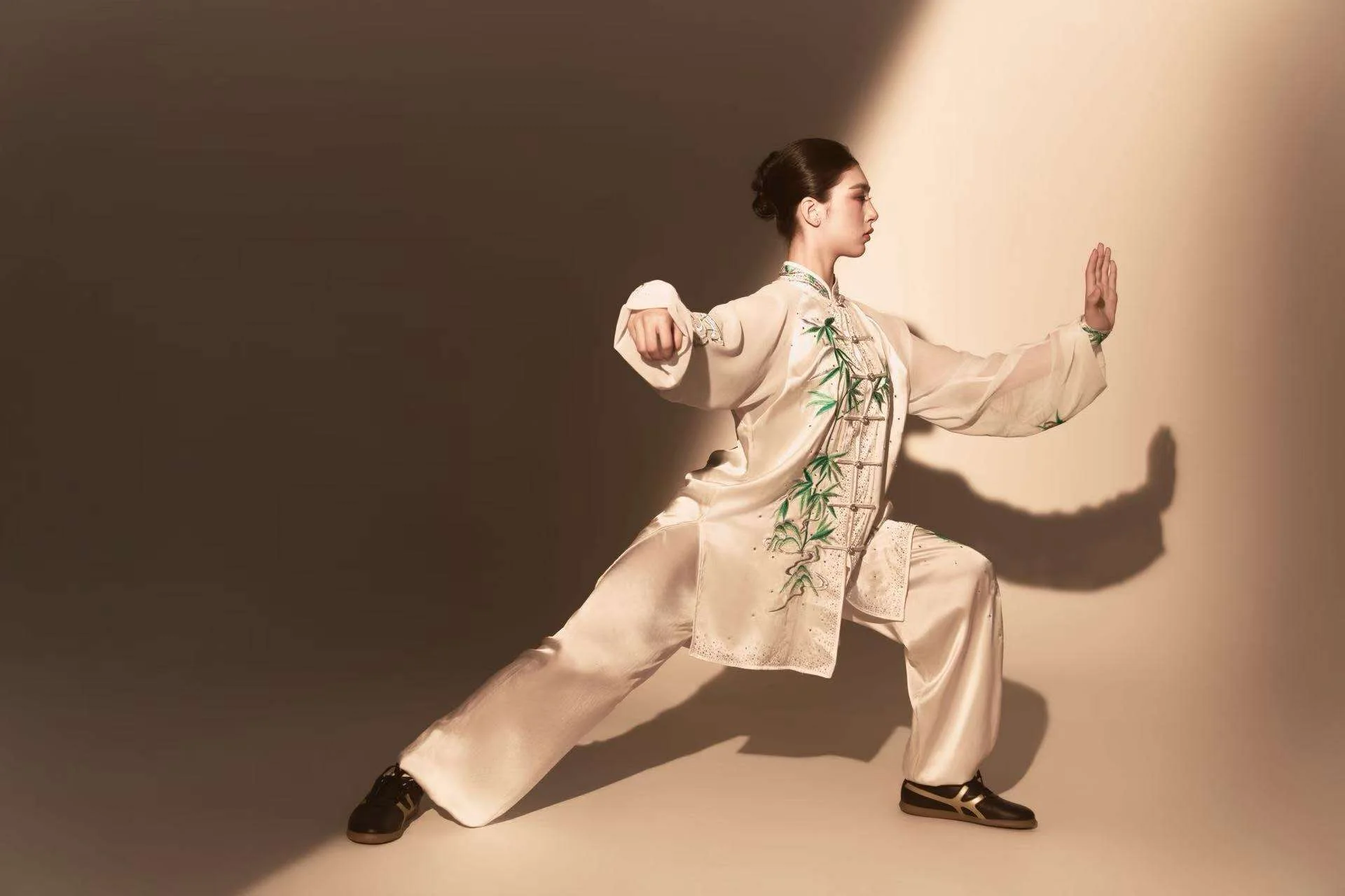 Annie Harris — wushu editorial, full body wide stance, warm spotlight background